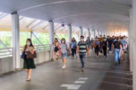 Blur of a lot of People Wear N95 for protect PM2.5 Dust at walk way of sky trainの写真素材