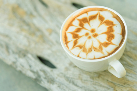hot cappuccino on wood table /hot cappuccino on wood plateの写真素材