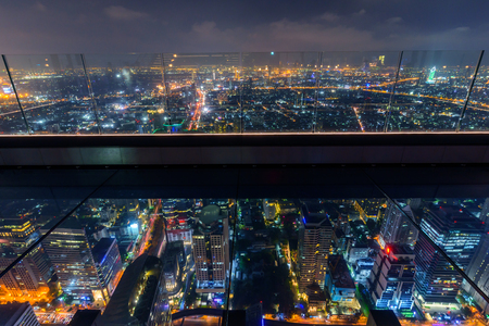 glass floor of high building transparent see true to building below in night timeの写真素材