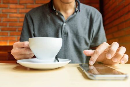 The man use smart phone in coffee shop