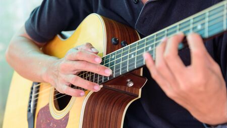 Playing acoustic guitar in the park