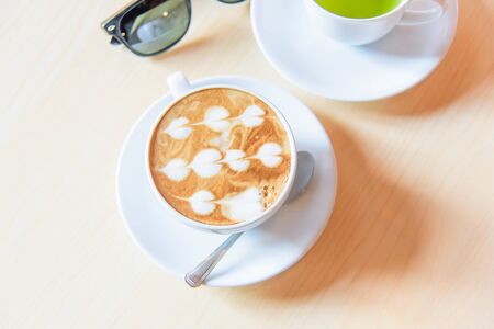 hot coffee on table / hot cappuccino with nice pattern milk foamの写真素材