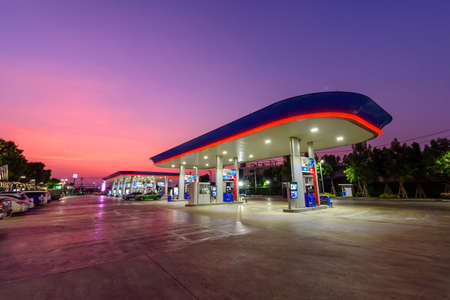 Samutsakhon, Thailand -  3  March,2020 :  PTT petrol station with a lot of car  in sunset timeのeditorial素材