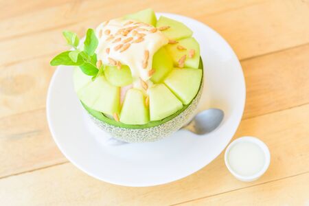 Melon Bingsu with Sweetened Condensed Milk on wood tableの写真素材