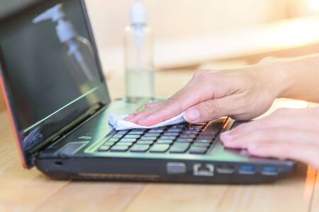 use alcohol gel to cleaning laptop for protect from disease covid-19