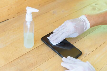 Cleaning smartphone by alcohol for protect your health from virusの写真素材