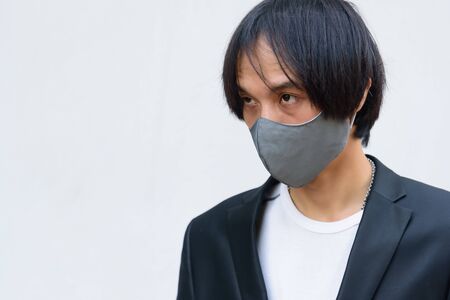 Asian man wear cloth mask for protect from covid-19 / cloth maskの写真素材