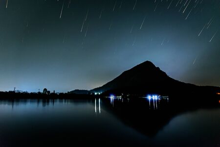 Startrails with silhouette mountain / long exposure technic with the starの写真素材