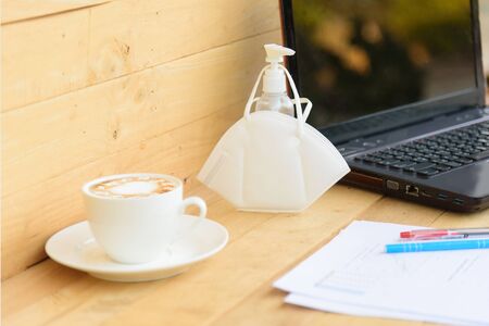 Work from home with hot coffee on the table / hot coffee with laptop on work spaceの写真素材