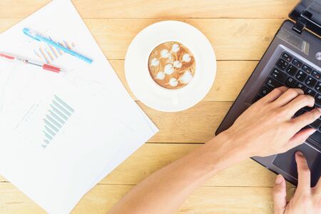 Work from home with hot coffee on the table / hot coffee with laptop on work spaceの写真素材