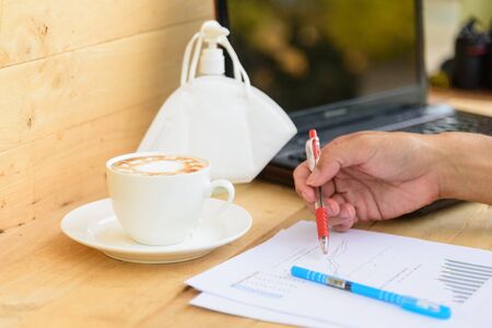 Work from home with hot coffee on the table / hot coffee with laptop on work spaceの写真素材