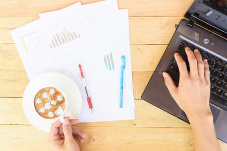 Work from home / The man use laptop and have a cup of hot coffee in working timeのeditorial素材