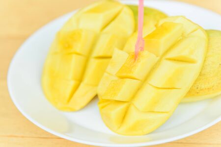 Ripe mango in the white dishの写真素材