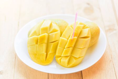 Ripe mango in the white dishの写真素材