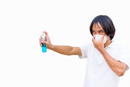 A asian man wear mask and spray the alcohol gel for cleaning disease with work path processの写真素材