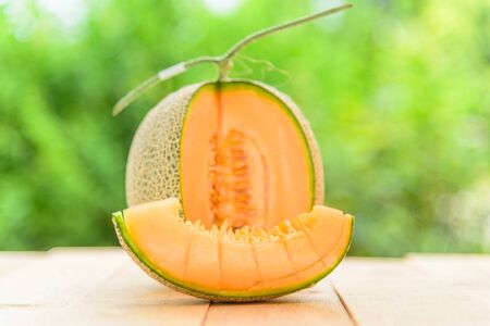 Fresh Orange melon on wood plateの写真素材
