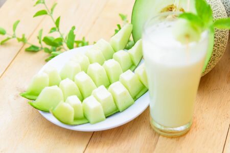 Fresh green melon on wood plateの写真素材