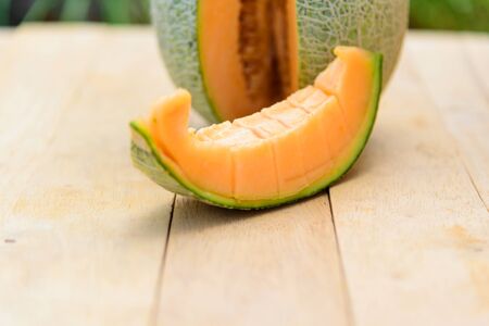 Fresh Orange melon on wood plateの写真素材