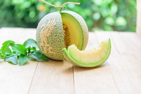 Fresh green melon with liverpool  logo on wood plateの写真素材