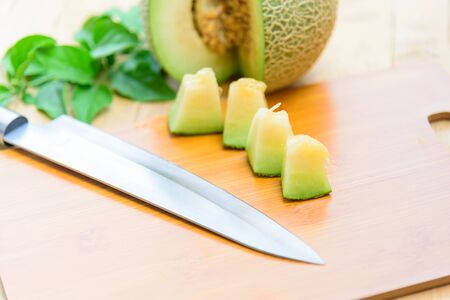Fresh green melon on wood plateの写真素材