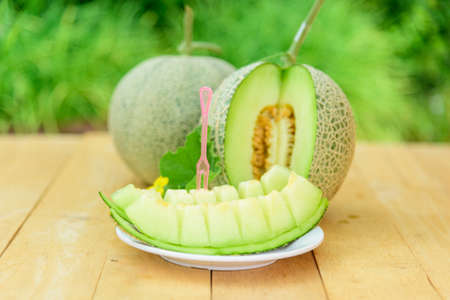 Fresh green melon on wood plateの写真素材