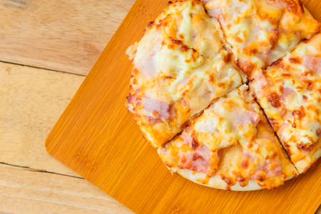 Home made pizza on wood plateの写真素材