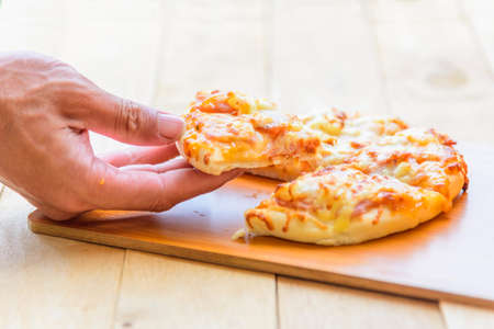 Home made pizza on wood plateの写真素材
