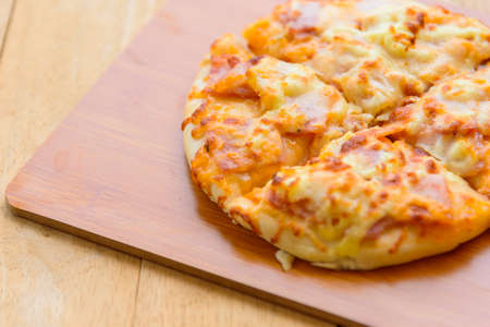 pizza Hawaiian Home made on wood plateの写真素材