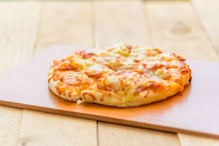 pizza Hawaiian Home made on wood plateの写真素材