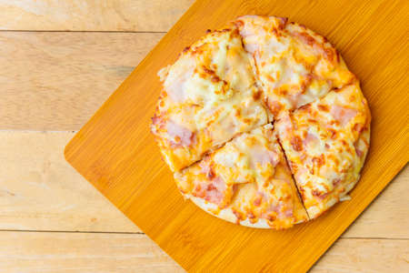 pizza Hawaiian Home made on wood plateの写真素材