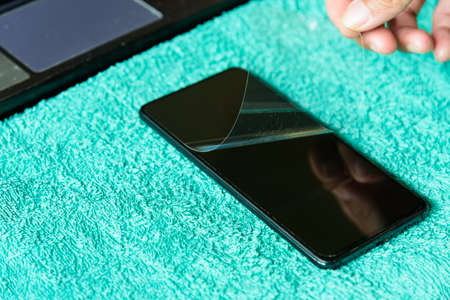 remove the old smart phone screen protect for replace itの写真素材