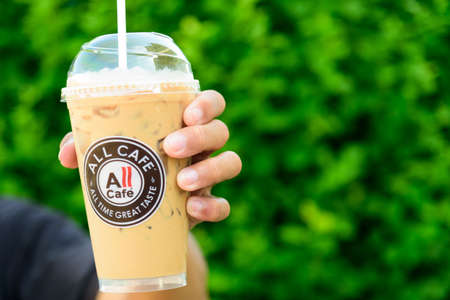 Bangkok, Thailand - 25  August, 2020 : The man hold ice coffee in glass of all cafe brandのeditorial素材