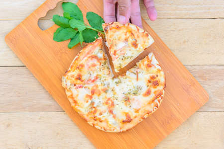 pizza Hawaiian Home made on wood plateの写真素材