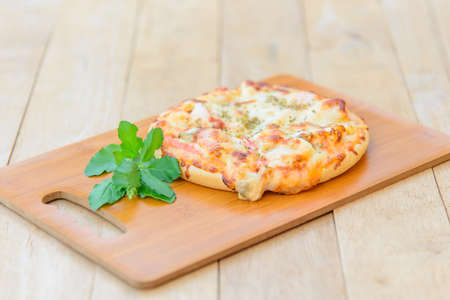 pizza Hawaiian Home made on wood plateの写真素材