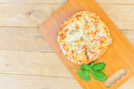 pizza Hawaiian Home made on wood plateの写真素材