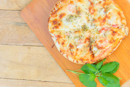 pizza Hawaiian Home made on wood plateの写真素材