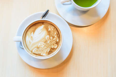 hot coffee on table / hot cappuccino with nice pattern milk foamの写真素材