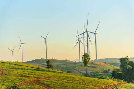 wind turbines park for make the electric power from wind in sunset time