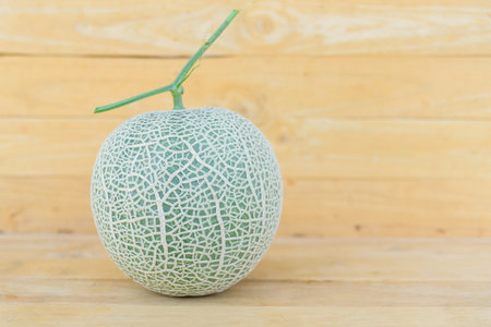 Nice fresh green melon on wood plateの写真素材
