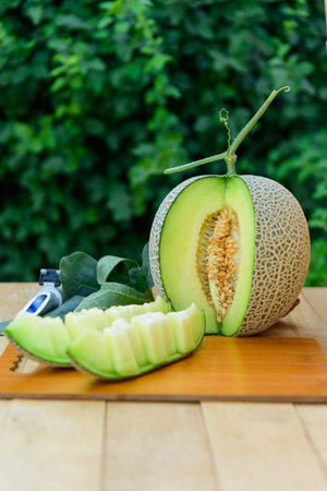 Fresh green melon on wood plateの写真素材