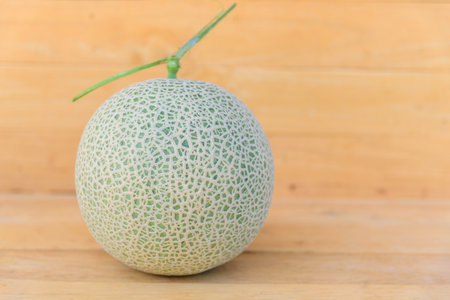 Fresh green melon on wood plateの写真素材