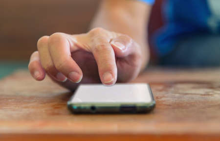 the man touch the screen for use social media on smartphoneの写真素材