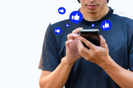 the man touch the screen for show Like emotion to social media on smartphoneの写真素材