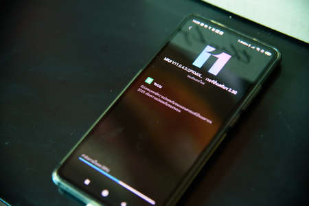 Rachaburi,Thailand - 18 Decemmber, 2020: Closeup focus to Smartphone model Mi9T updating OS android...