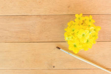 paintbrush and melon flower on wood plate - Item for Pollinate of Melon flowerの写真素材