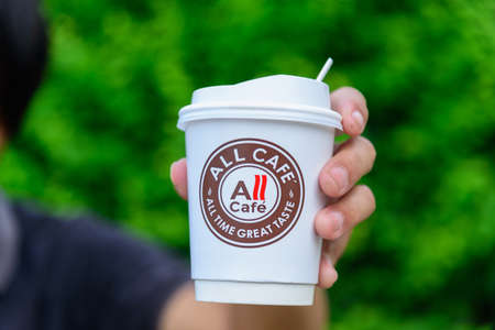 Bangkok,Thailand - 6 April, 2021: The man hold the paper cup of all cafe of hot coffee