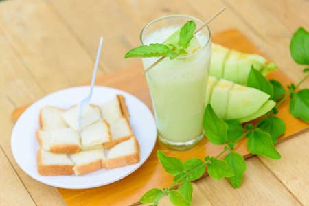 Milk melon Smoothie in glass with Roast breadの写真素材
