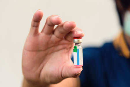 The man hold the Vaccine for treat the peopleの写真素材