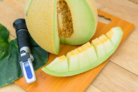 piece of fresh yellow galia melon on the plateの写真素材