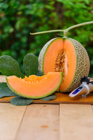 a lot of piece of fresh orange melon on the plateの写真素材